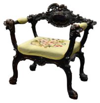 UNUSUAL LATE 19th CENTURY CARVED AND STAINED TACKROOM CHAIR with carved mask terminals and paw feet,