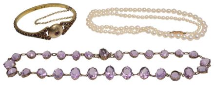 A slightly graduated oval amethyst riviere necklace