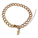 A gold curb link charm bracelet