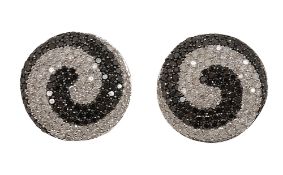 A pair of black and white diamond earrings