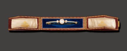 A mid/late Victorian pearl, diamond and enamel hinged bangle