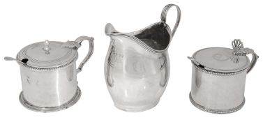 A George III silver mustard pot, a cream jug and a Victorian mustard pot