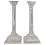 A large pair of Elizabeth II silver Corinthian column candlesticks