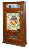 An oak cased hanging pinball machine