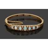 A late 19th/early 20th century opal and diamond-set hinged bangle