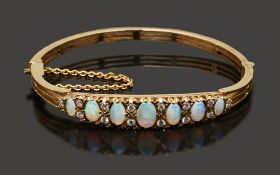 A late 19th/early 20th century opal and diamond-set hinged bangle