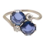 A sapphire and diamond cross-over ring