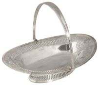 An Edwardian silver pierced swing handled cake basket