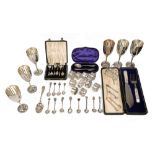 A collection of silver to include cased sets, napkin rings, and souvenir coffee spoons