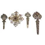 A late 19th century Ceylonese starburst brooch and three turban pins