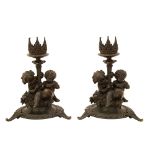 A pair of late 19th century French patinated bronze candlesticks by Fanniere Freres