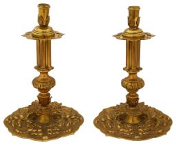 A pair of early 20th century Charles II style cast brass candlesticks