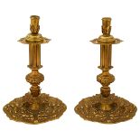 A pair of early 20th century Charles II style cast brass candlesticks