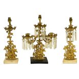 A mid 19th century American gilt metal garniture of lustre candlesticks, adapted as lamps