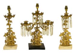 A mid 19th century American gilt metal garniture of lustre candlesticks, adapted as lamps