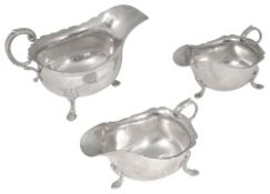A George V silver sauce boat and a pair of Elizabeth II sauce boats