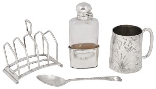 A Vict. silver christening mug and spoon, a toast rack and a silver mounted flask
