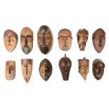 A group of twelve small tribal carved wood masks