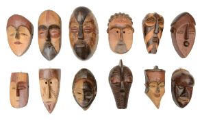 A group of twelve small tribal carved wood masks