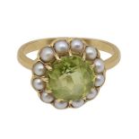 A peridot and seed pearl circular cluster ring