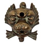 A cast bronze dolphin mask wall fountain water spout