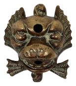 A cast bronze dolphin mask wall fountain water spout