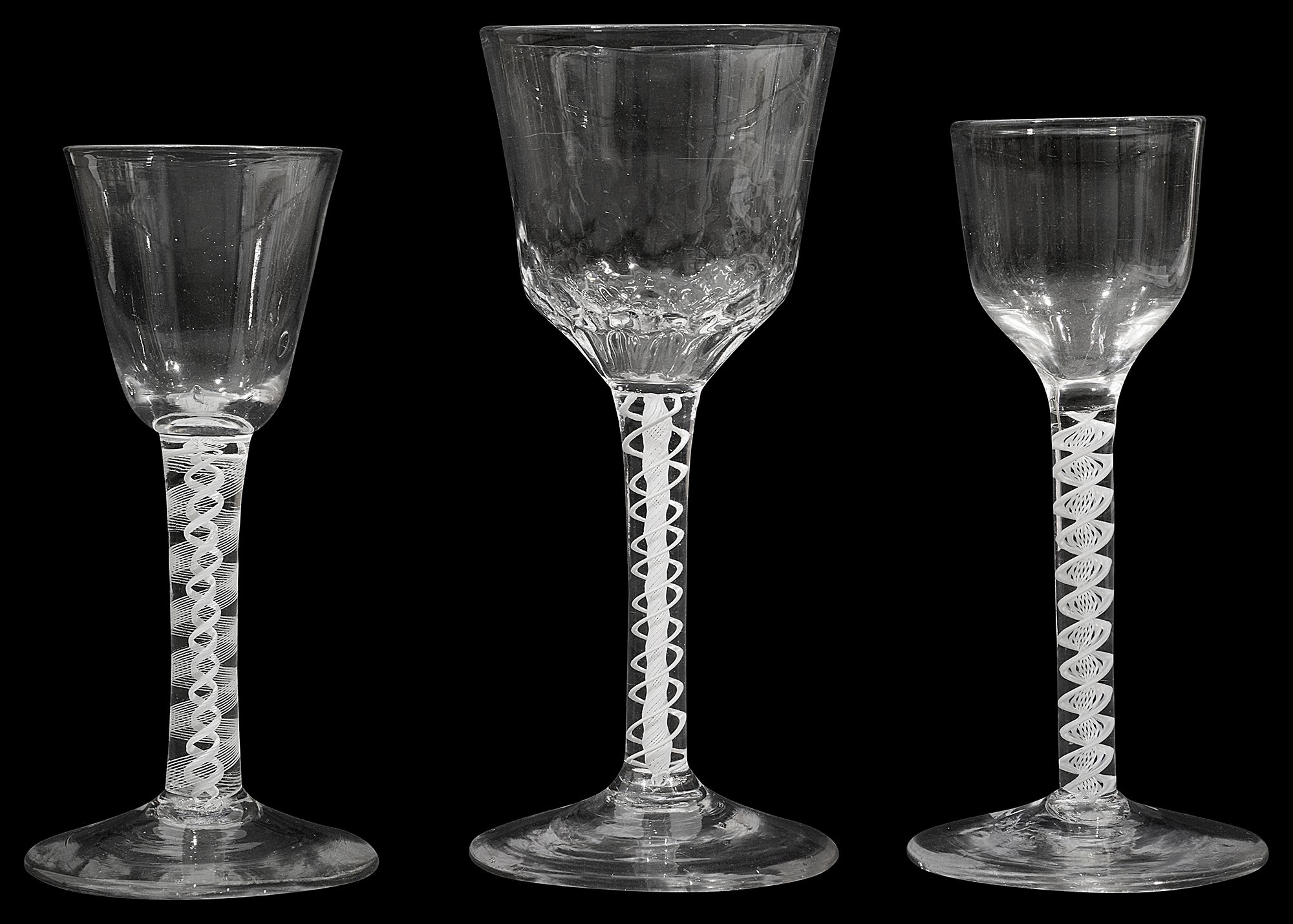 Three mid 18th century opaque twist stemmed wine glasses