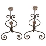 A pair of Edwardian Arts and Crafts wrought iron andirons