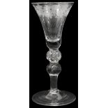 A mid 18th century engraved light baluster wine glass c.1750