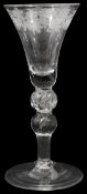 A mid 18th century engraved light baluster wine glass c.1750