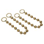 A pair of Victorian brass bead curtain tie backs