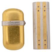 A Cartier two tone pocket lighter and another by Yves St Laurant