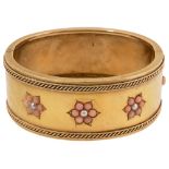 A Victorian yellow gold, coral and seed pearl hinged bangle