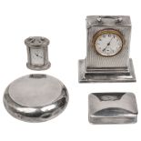 A silver desk timepiece, a tobacco box and a pill box