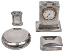 A silver desk timepiece, a tobacco box and a pill box