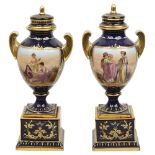 A pair of late 19th century Vienna style porcelain urns and covers