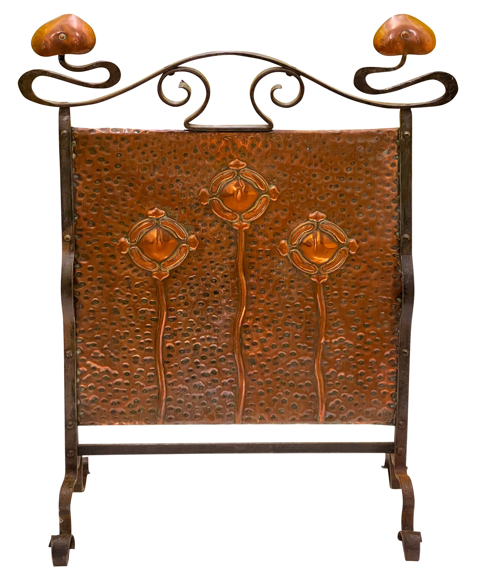 An Arts & Crafts wrought iron and copper firescreen