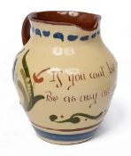 An early 20th century Longpark Torquay pottery mottoware jug