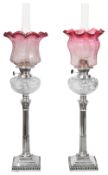 A pair of late Victorian silver and cut glass oil lamps