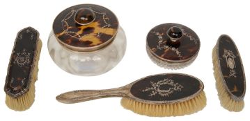 A silver powder jar, a smaller jar and 3 brushes