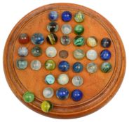 A 19th century treen birch solitaire board and glass marbles