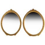 A pair of late 19th century gilt gesso framed oval mirrors