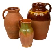 A large pottery jug and two further examples