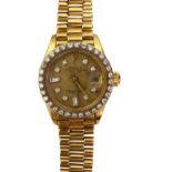 A lady's 18K yellow gold and diamond Rolex Oyster Watch