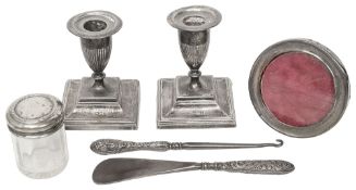A pair of silver dwarf candlesticks, a photo frame & other silver