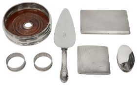 A engine turned cigarette case, a bottle coaster and other silver