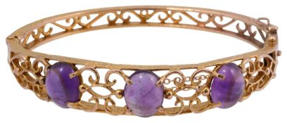 An amethyst and 9ct yellow gold hinged bangle