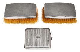 A George V silver cigarette case and a pair of clothes brushes