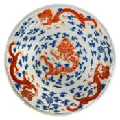 A Chinese blue, white and iron red porcelain dragon dish