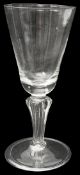A mid 18th century continental soda glass moulded stem wine glass